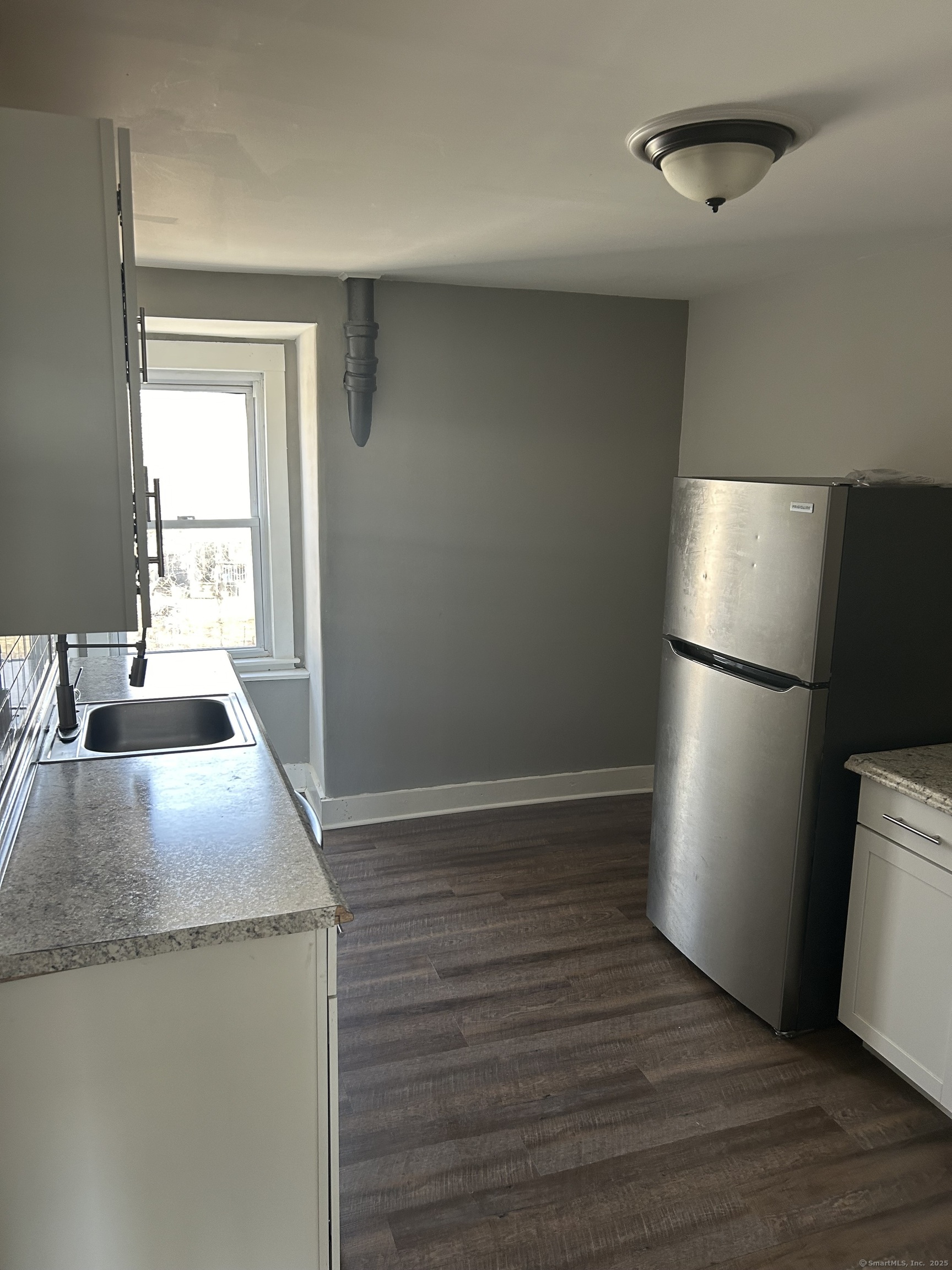 215 Providence Street, Unit 3A Putnam, CT 06260 - Photo 1 of 1 a kitchen with granite countertop a sink and a refrigerator