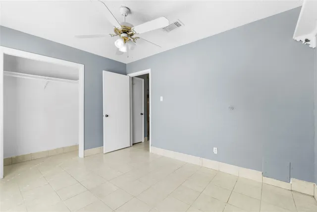 a view of an empty room with a ceiling fan