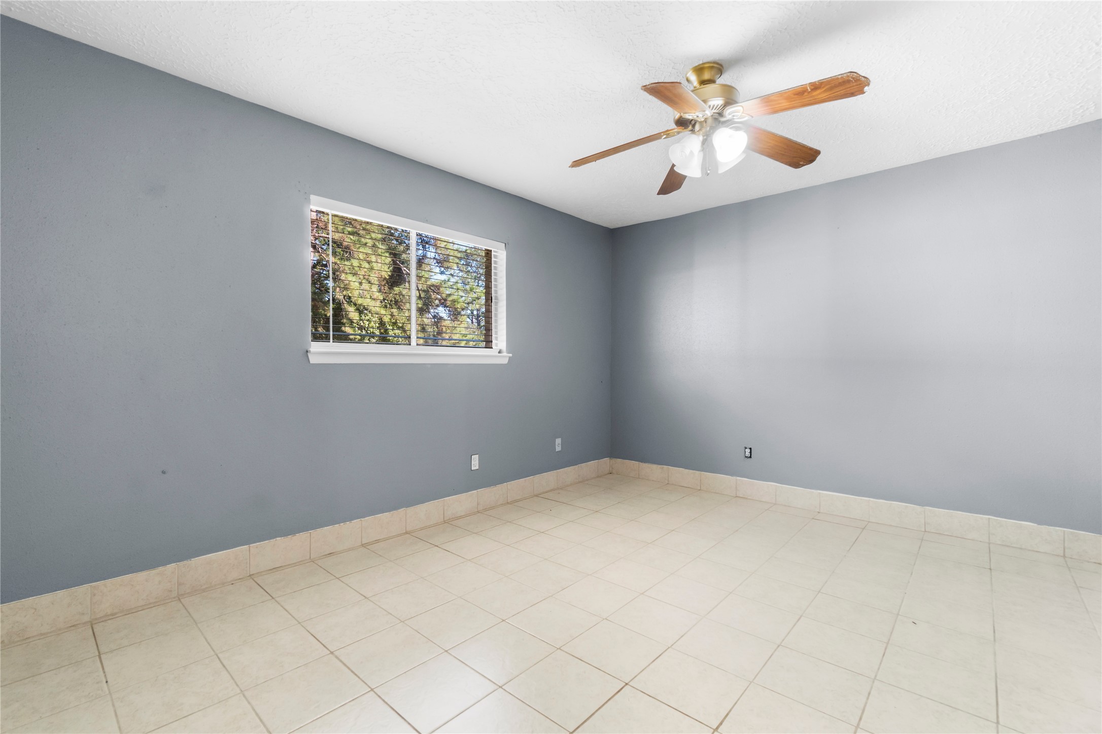 23202 Summergate Drive Spring, TX 77373 - Photo 13 of 16 an empty room with a chandelier fan and window
