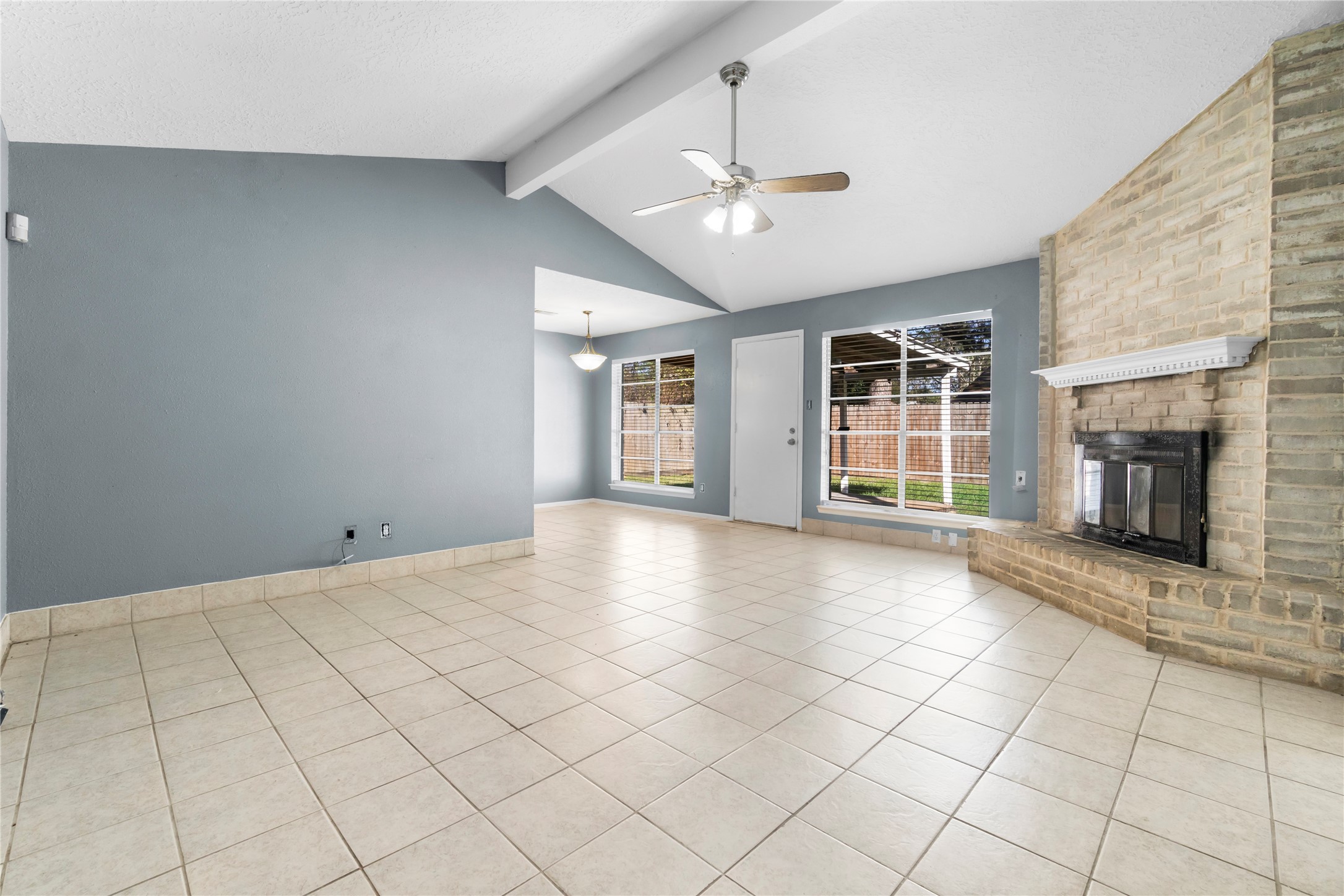 23202 Summergate Drive Spring, TX 77373 - Photo 6 of 16 a view of an empty room with a fireplace and a window