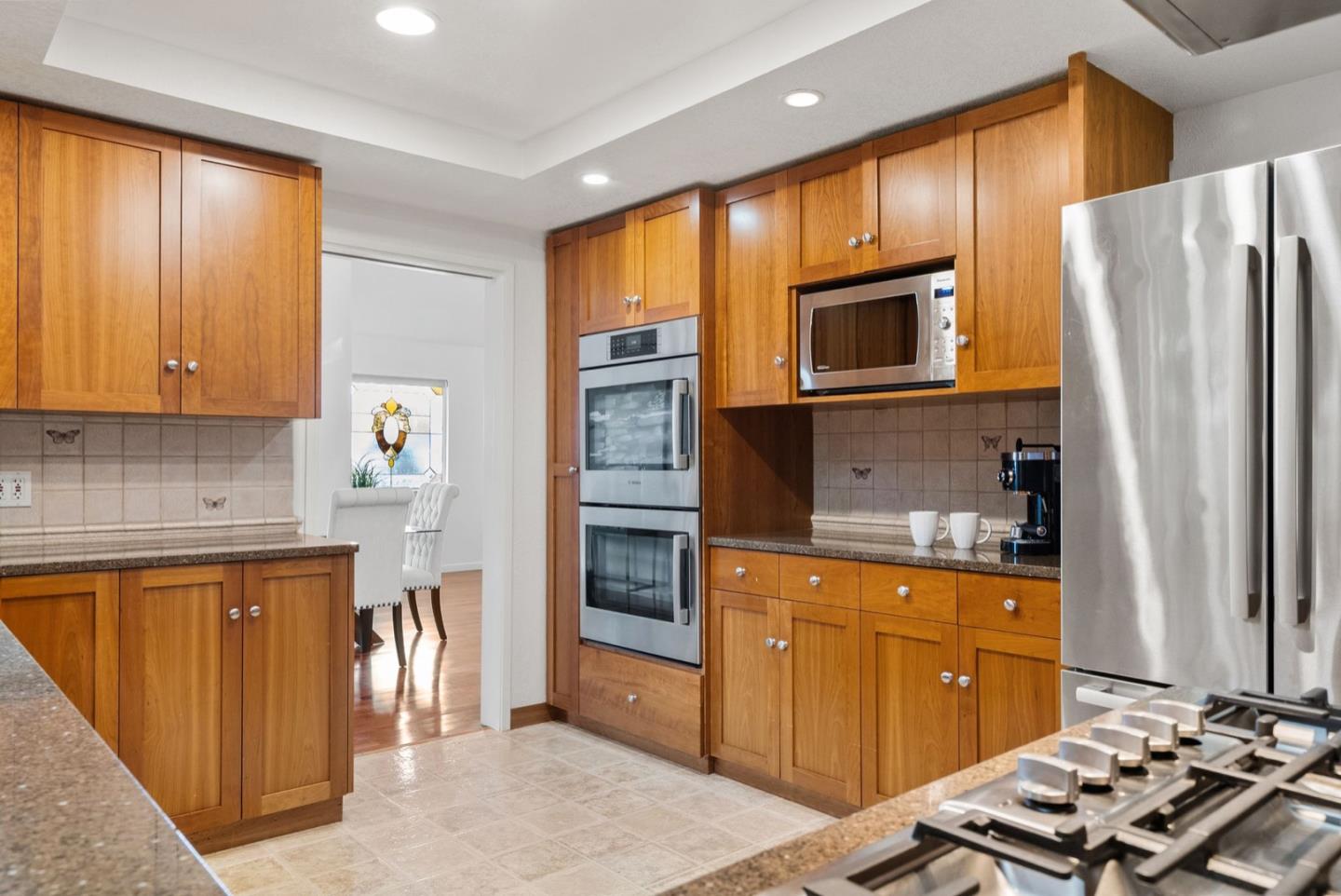 28 Cobblestone Lane Belmont, CA 94002 - Photo 12 of 45 a kitchen with stainless steel appliances granite countertop a refrigerator stove and sink
