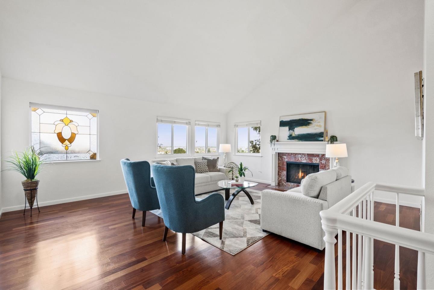 28 Cobblestone Lane Belmont, CA 94002 - Photo 18 of 45 a living room with furniture a fireplace and a wooden floor