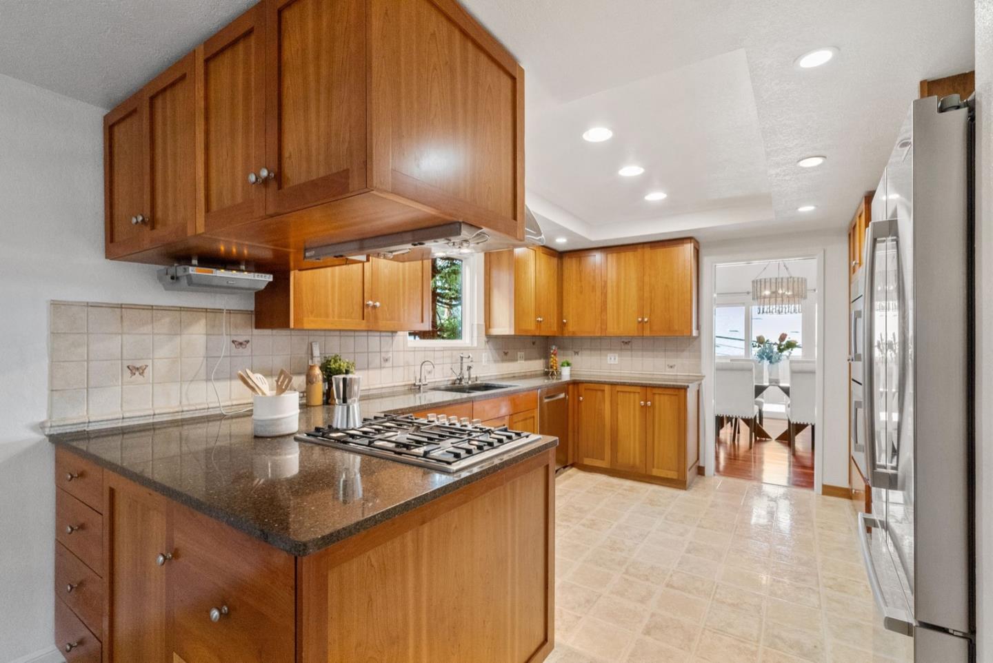 28 Cobblestone Lane Belmont, CA 94002 - Photo 10 of 45 a kitchen with a sink a stove cabinets and a kitchen island