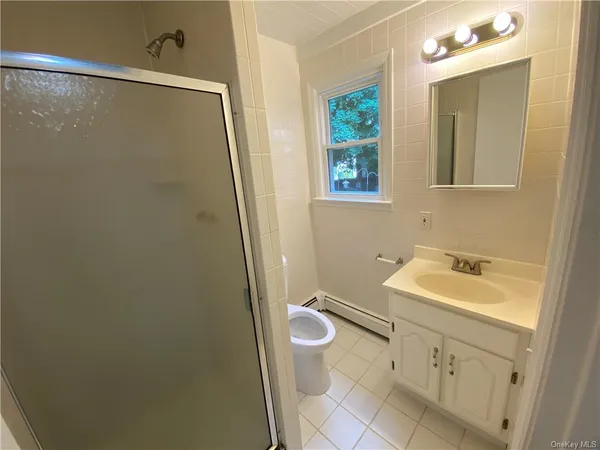 a bathroom with a sink and mirror with toilet