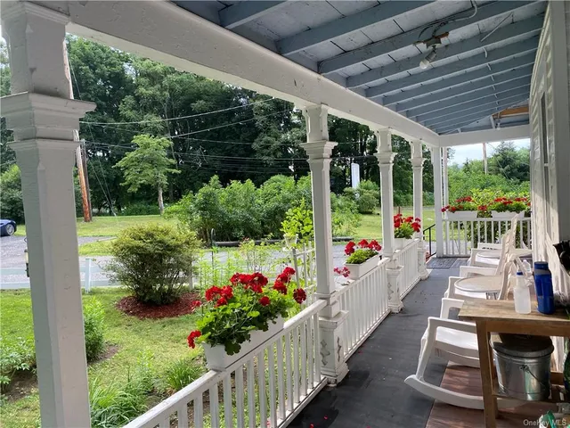 a view of a porch with wooden floor