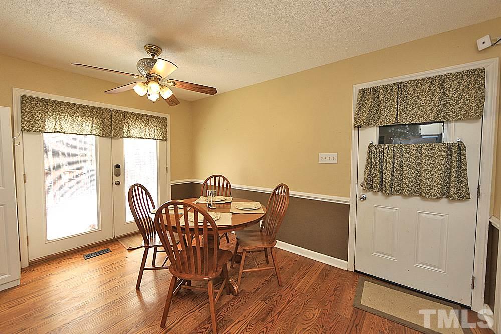 7210 Kemp Road Raleigh, NC 27613 - Photo 4 of 20 a view of a dining room with furniture window and wooden floor