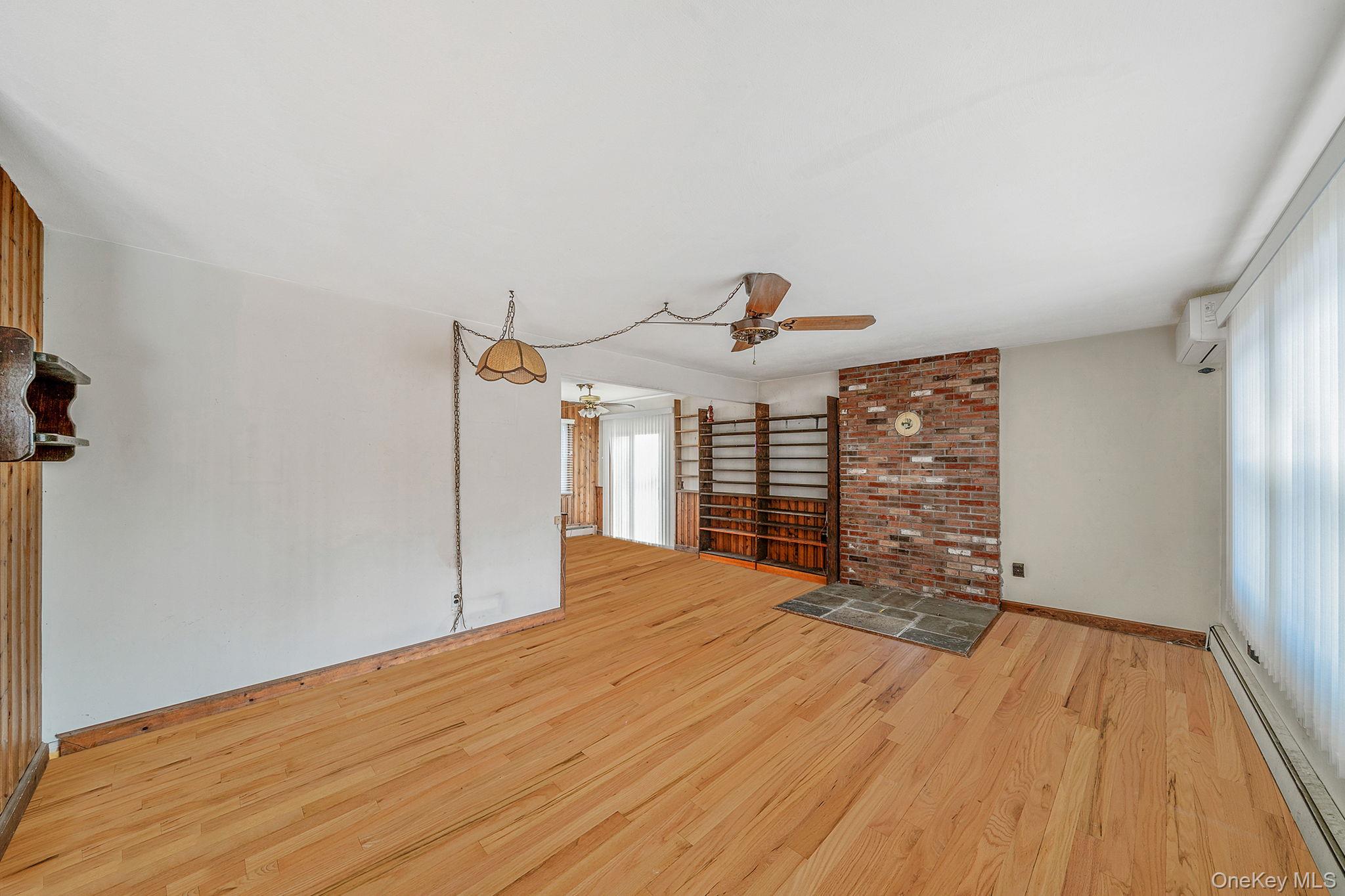 120 Rustic Road Port Jefferson, NY 11777 - Photo 13 of 45 a big room with wooden floor and windows