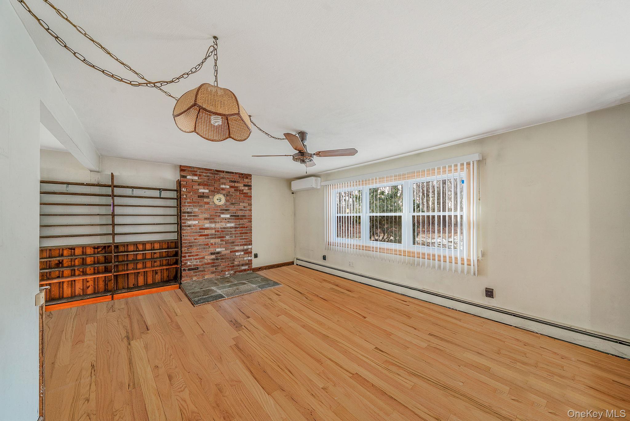 120 Rustic Road Port Jefferson, NY 11777 - Photo 14 of 45 a view of an empty room with a window and wooden floor