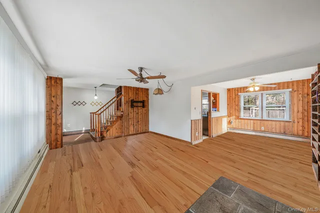 a big room with wooden floor and windows