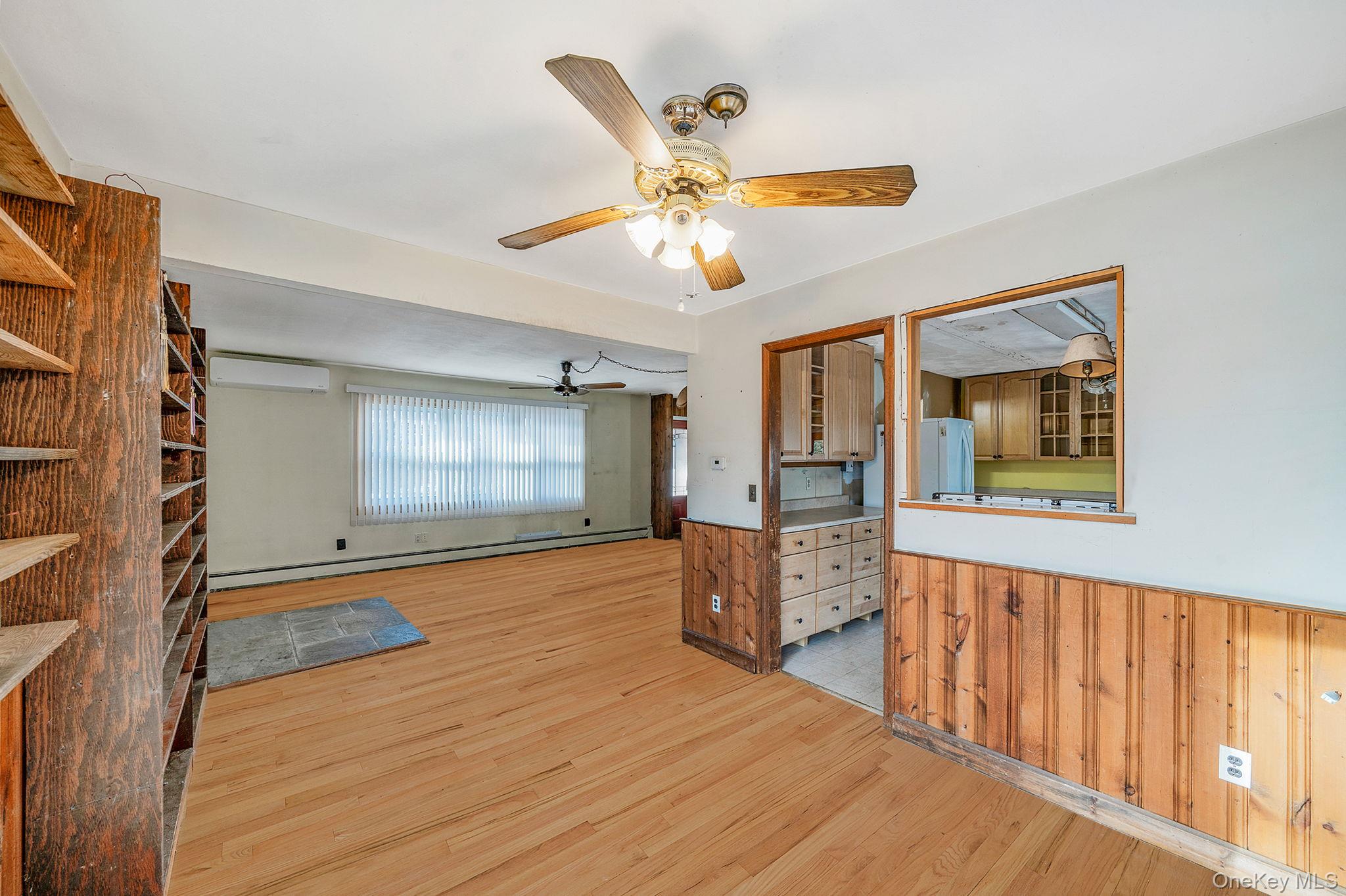 120 Rustic Road Port Jefferson, NY 11777 - Photo 17 of 45 a view of an empty room with window and wooden floor