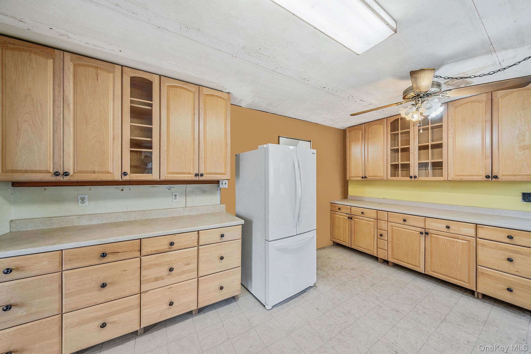 120 Rustic Road Port Jefferson, NY 11777 - Photo 18 of 45 a kitchen with cabinets stainless steel appliances a sink and wooden cabinets