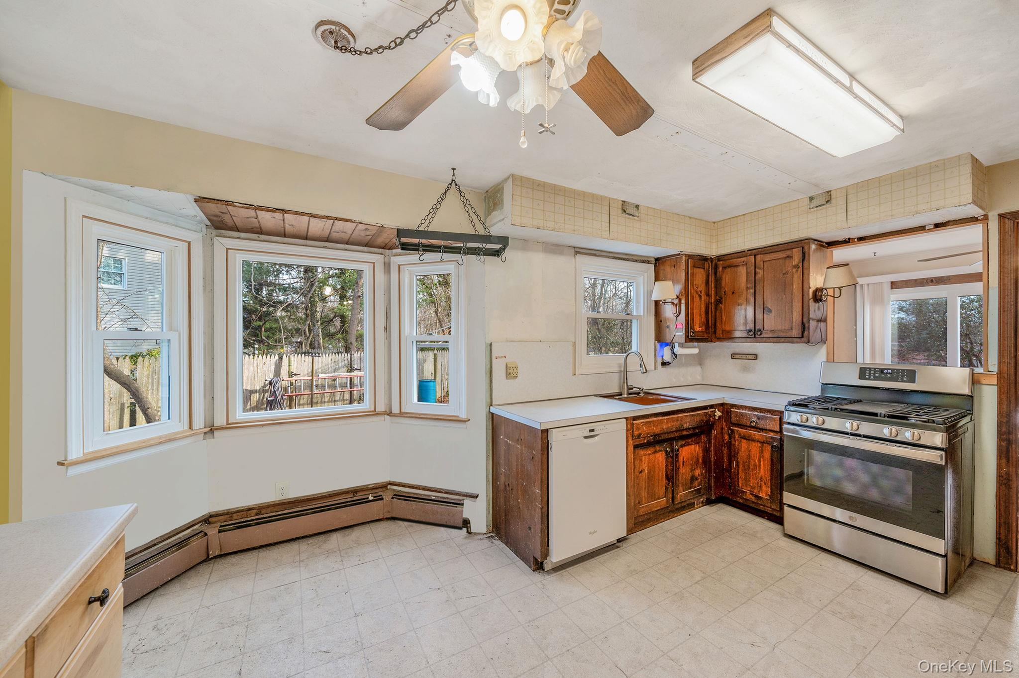 120 Rustic Road Port Jefferson, NY 11777 - Photo 20 of 45 a kitchen with stainless steel appliances granite countertop a stove and a refrigerator