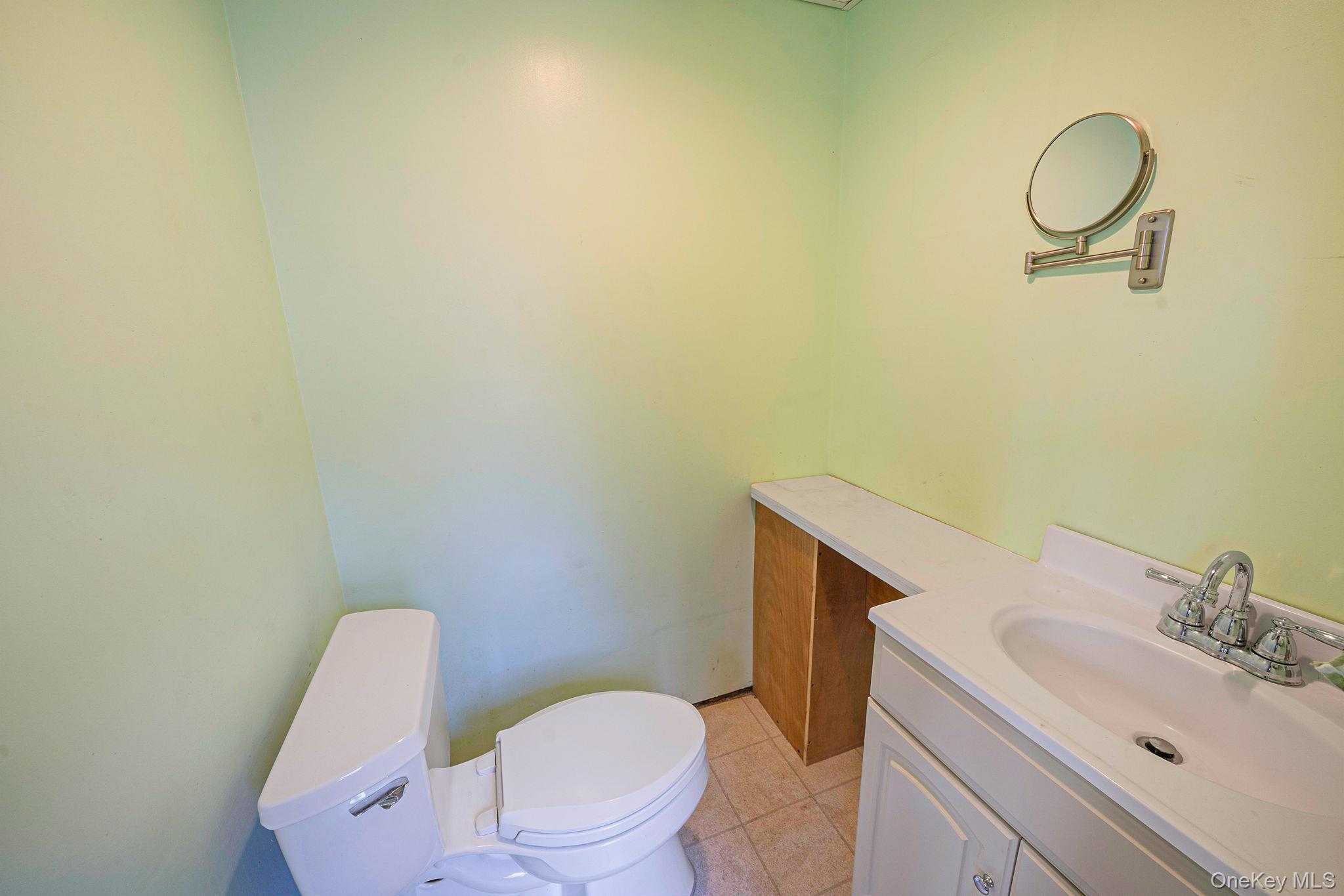 120 Rustic Road Port Jefferson, NY 11777 - Photo 21 of 45 a white toilet sitting next to a bathroom sink