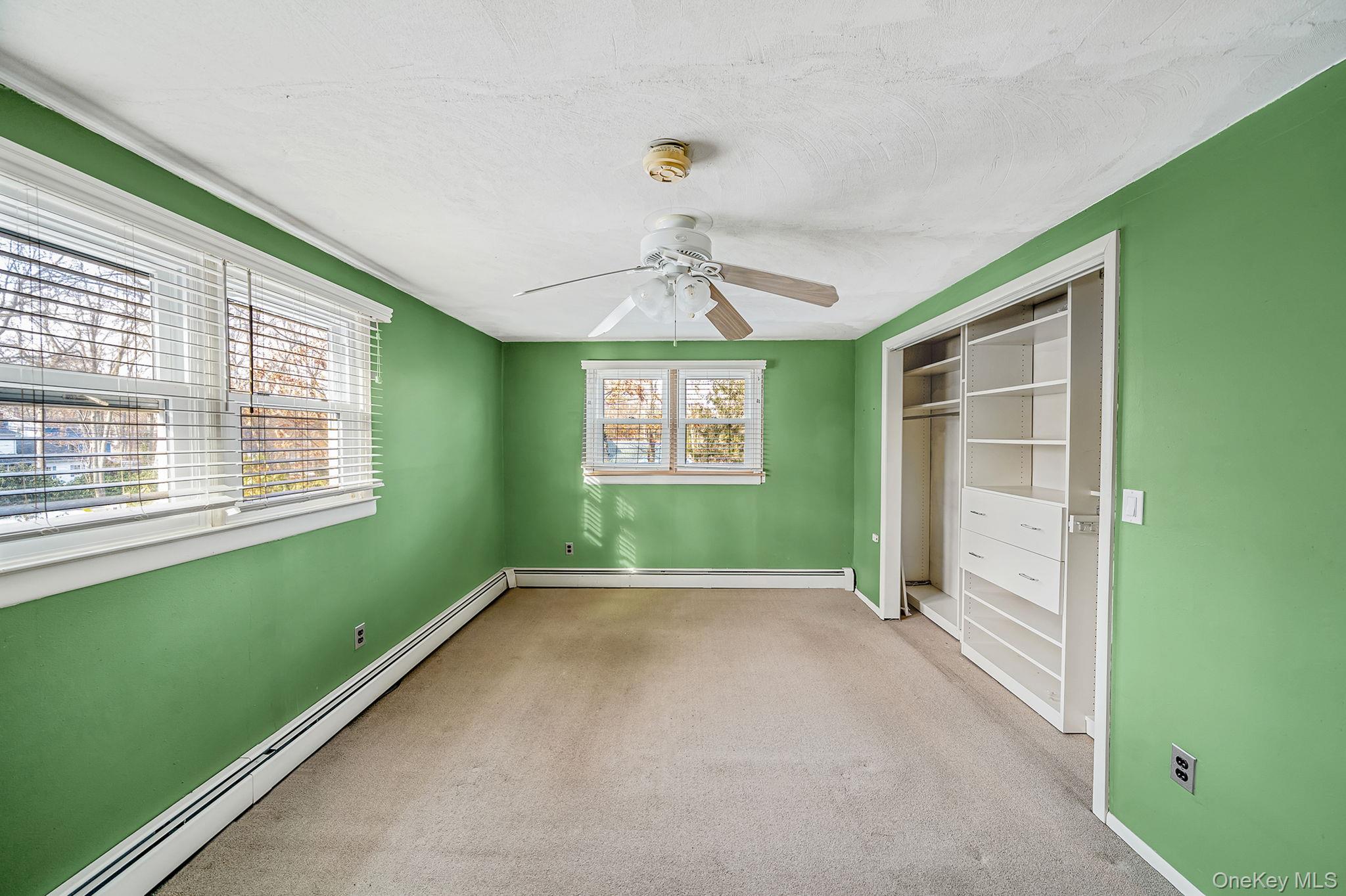 120 Rustic Road Port Jefferson, NY 11777 - Photo 26 of 45 a view of an empty room with a window and a ceiling fan