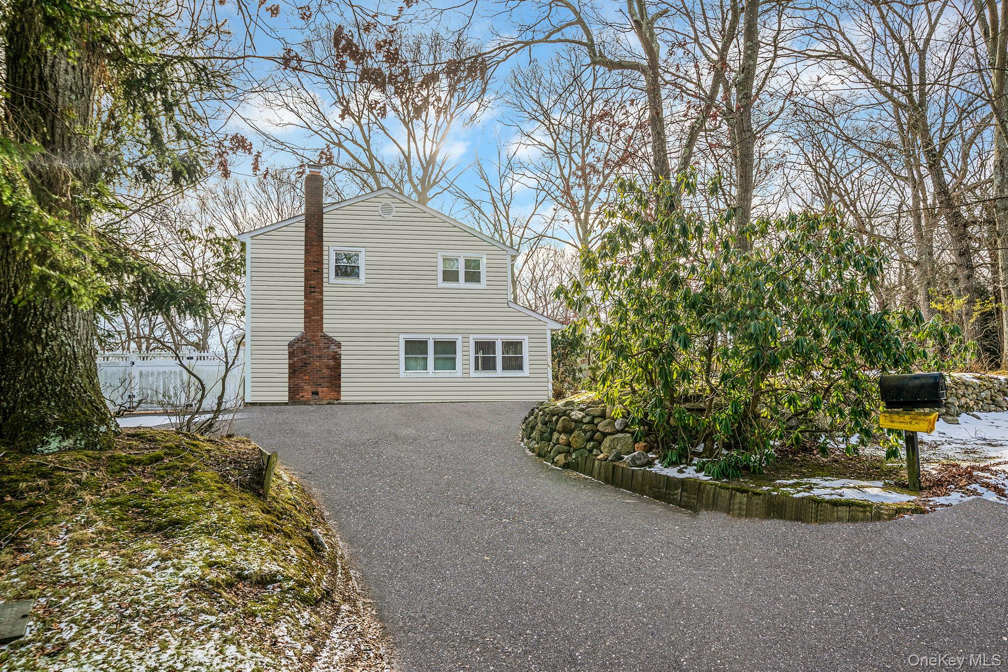 120 Rustic Road Port Jefferson, NY 11777 - Photo 3 of 45 View of home's exterior featuring driveway and a chimney