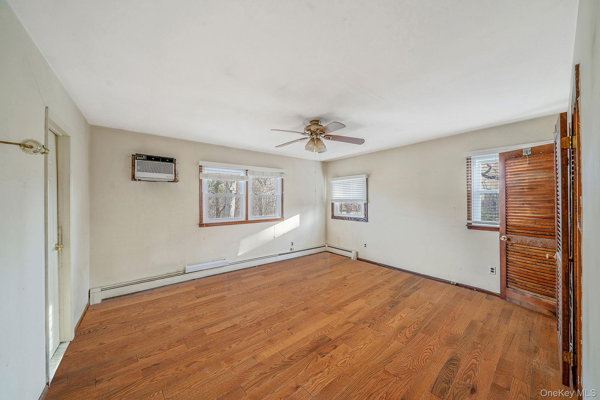 120 Rustic Road Port Jefferson, NY 11777 - Photo 34 of 45 wooden floor in an empty room with a window