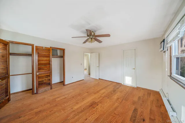 a big room with closet and a ceiling fan