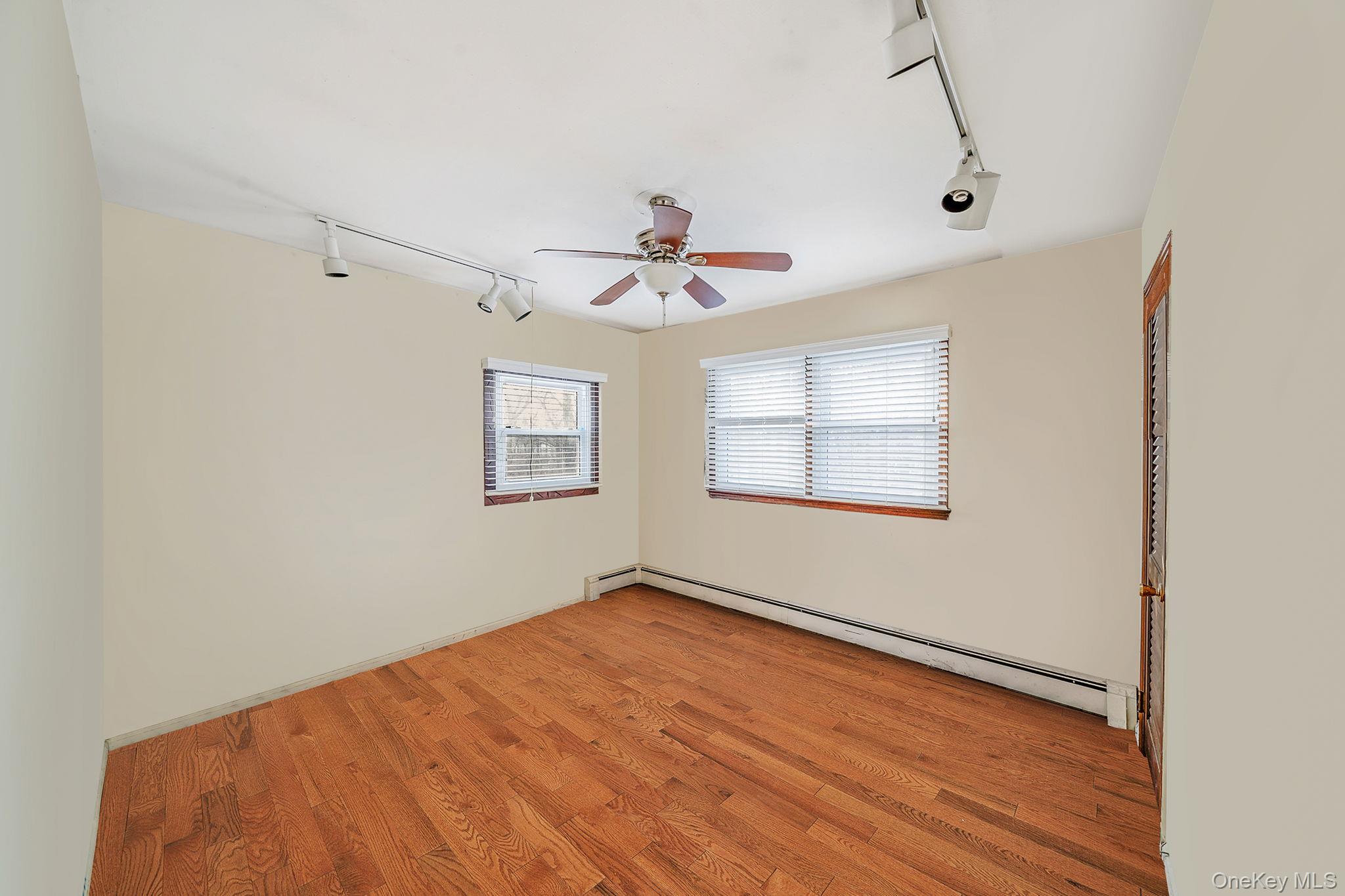 120 Rustic Road Port Jefferson, NY 11777 - Photo 36 of 45 a view of a room with a ceiling fan and a window