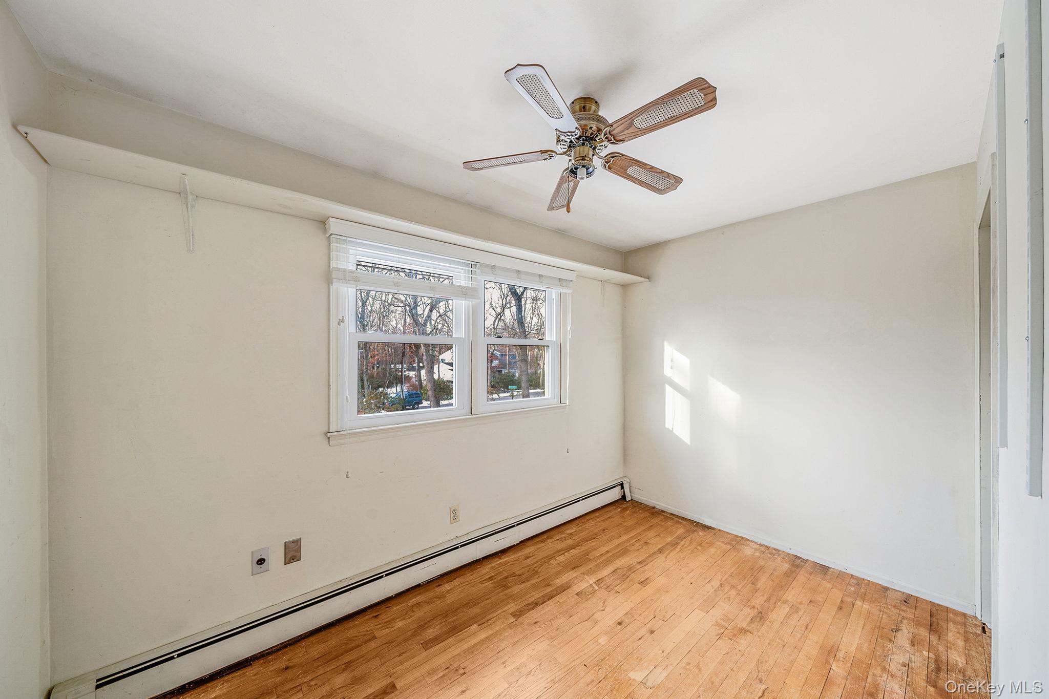 120 Rustic Road Port Jefferson, NY 11777 - Photo 38 of 45 a view of a big room with wooden floor and windows