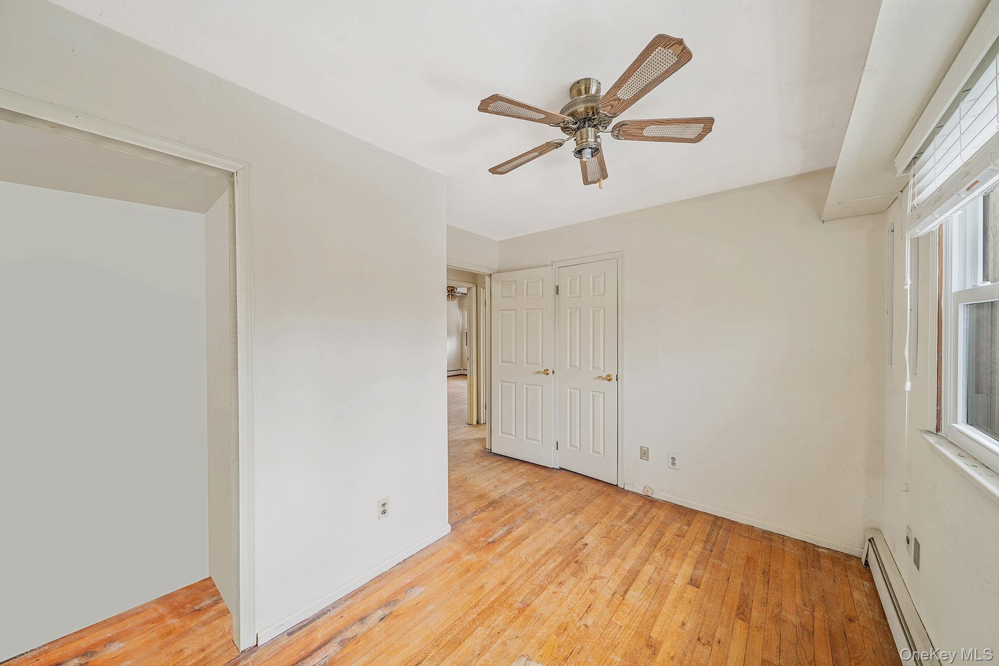 120 Rustic Road Port Jefferson, NY 11777 - Photo 39 of 45 a view of a room with wooden floor and white walls
