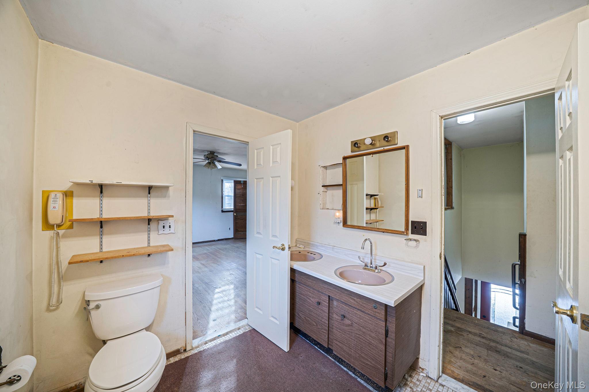 120 Rustic Road Port Jefferson, NY 11777 - Photo 40 of 45 a bathroom with a toilet a sink a mirror and a shower
