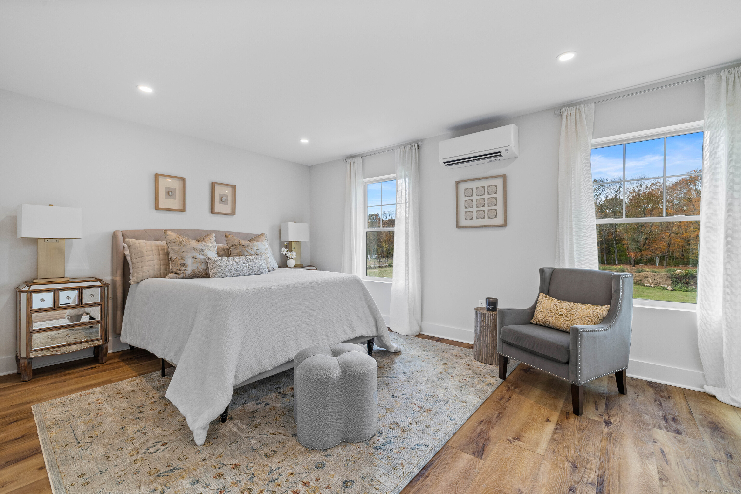 138 Boston Post Road, Unit 16 East Lyme, CT 06333 - Photo 21 of 35 a bedroom with a bed and wooden floor