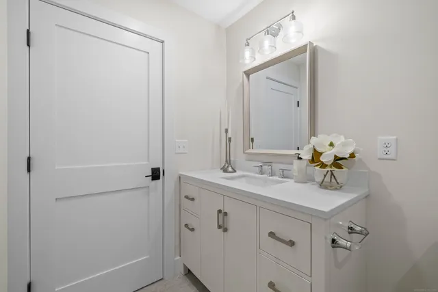 a bathroom with a sink a mirror and a shower