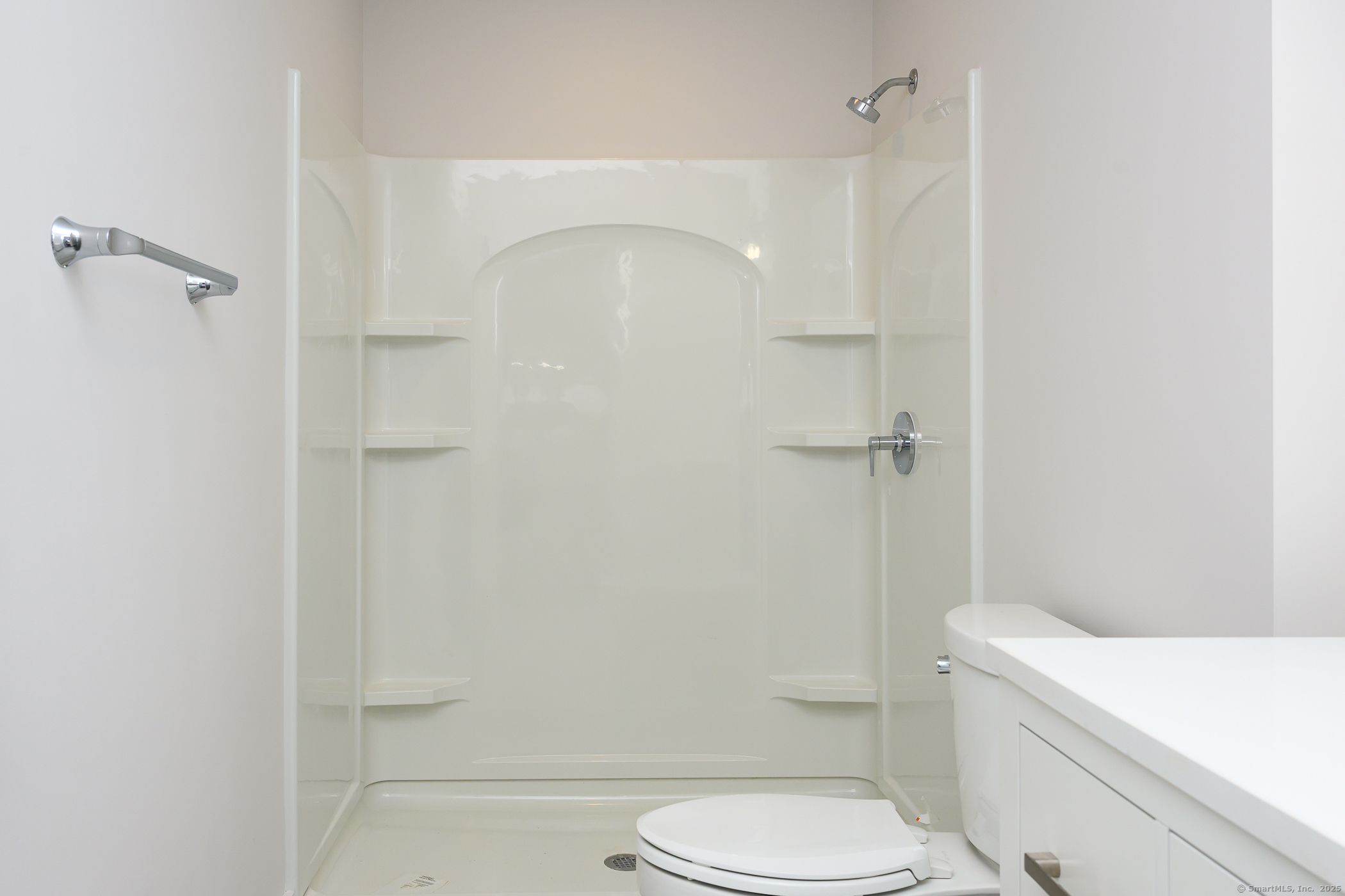 138 Boston Post Road, Unit 16 East Lyme, CT 06333 - Photo 23 of 35 a white toilet sitting next to a bathroom sink