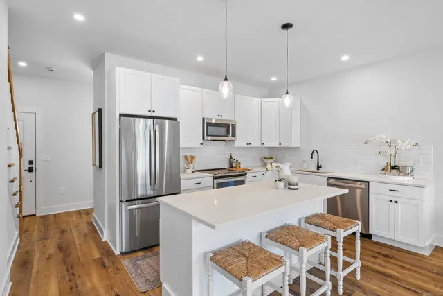 a kitchen with white cabinets and stainless steel appliances