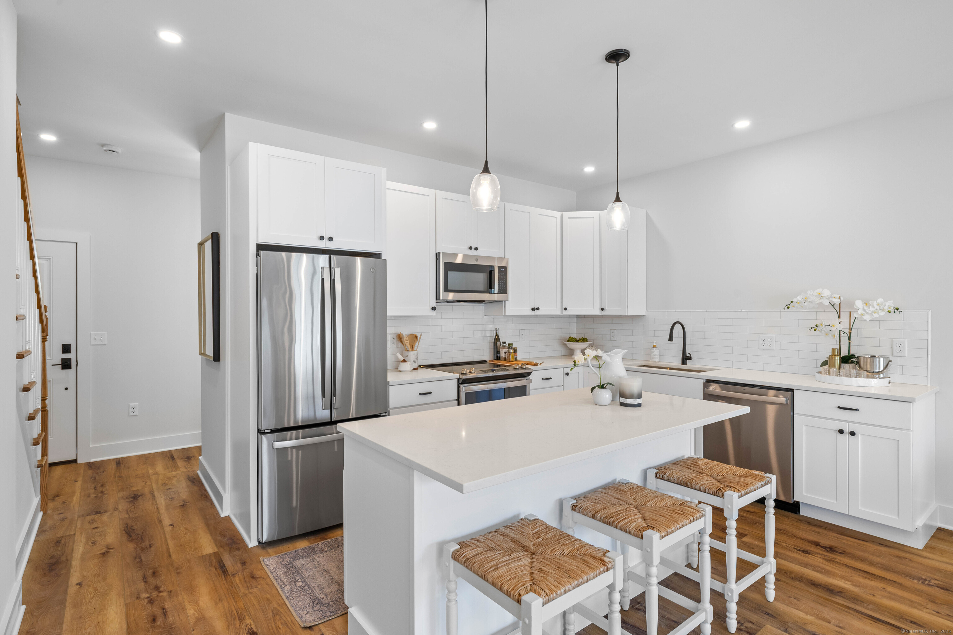 138 Boston Post Road, Unit 16 East Lyme, CT 06333 - Photo 8 of 35 a kitchen with white cabinets and stainless steel appliances