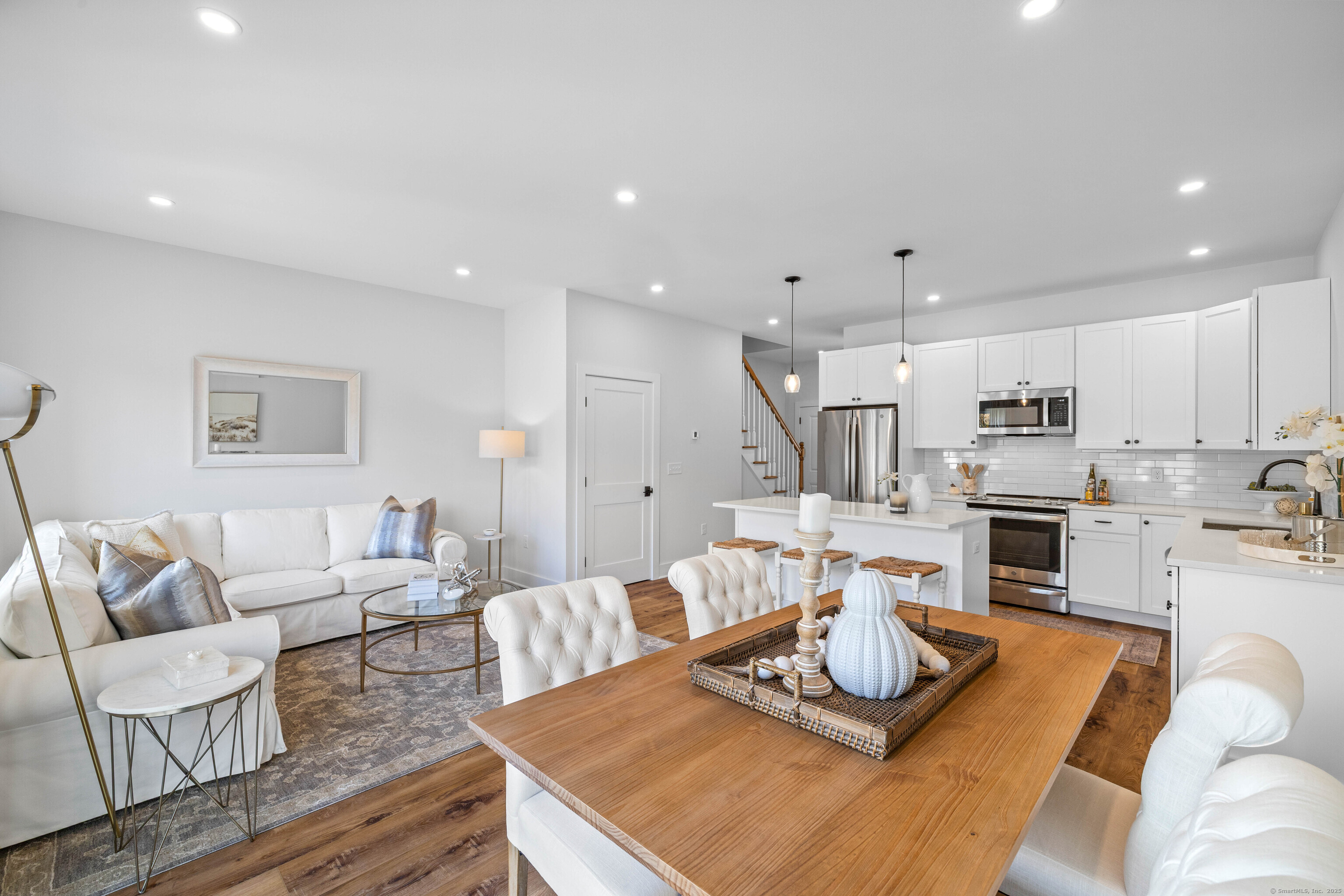 138 Boston Post Road, Unit 16 East Lyme, CT 06333 - Photo 10 of 35 a living room with kitchen island furniture and a wooden floor