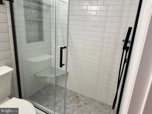 a bathroom with a shower and toilet