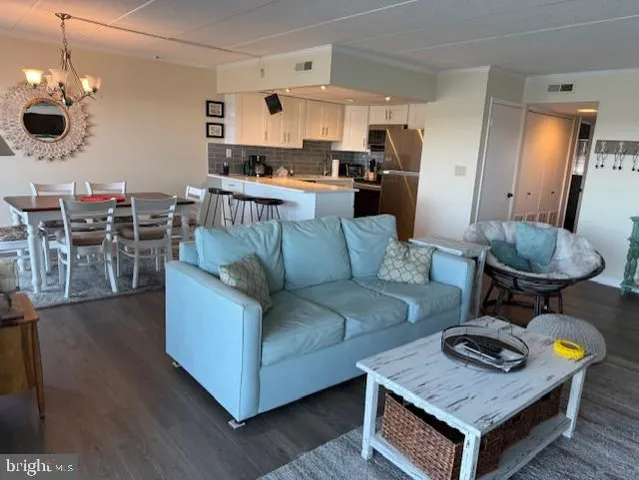 a living room with furniture and a dining table