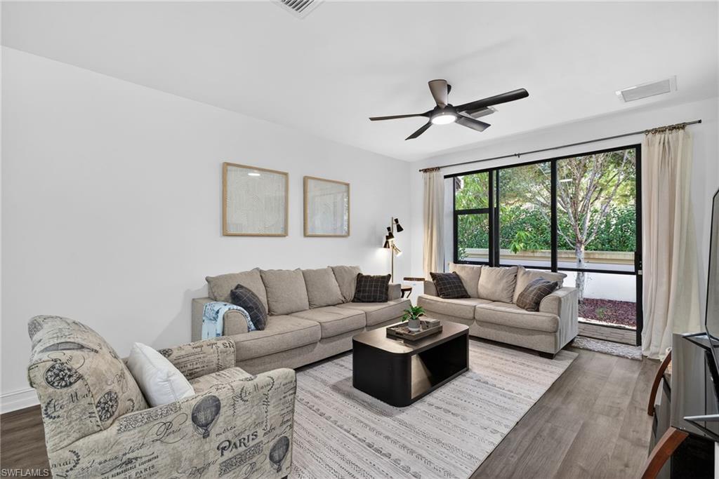 7845 Bristol Circle Naples, FL 34120 - Photo 6 of 31 a living room with furniture and a large window