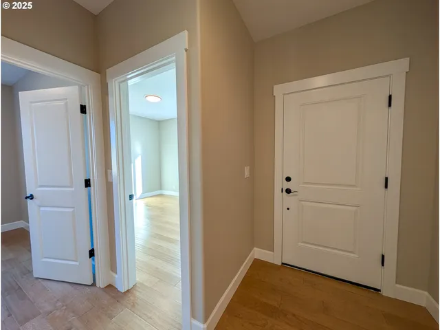 an empty room with wooden floor and cabinet