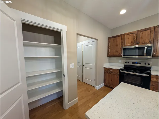 a kitchen with a refrigerator stove and microwave
