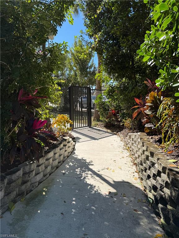 1033 Egrets Walk Circle, Unit 203 Naples, FL 34108 - Photo 13 of 35 a street view with tall trees