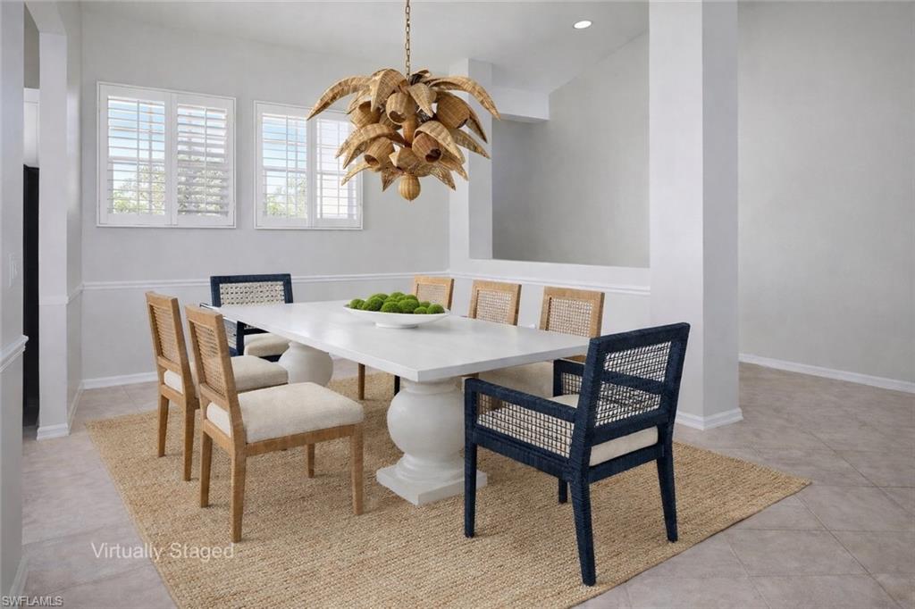 1033 Egrets Walk Circle, Unit 203 Naples, FL 34108 - Photo 2 of 35 a view of a dining room with furniture
