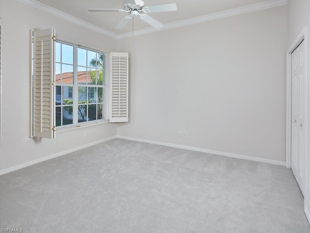 1033 Egrets Walk Circle, Unit 203 Naples, FL 34108 - Photo 21 of 35 an empty room with windows