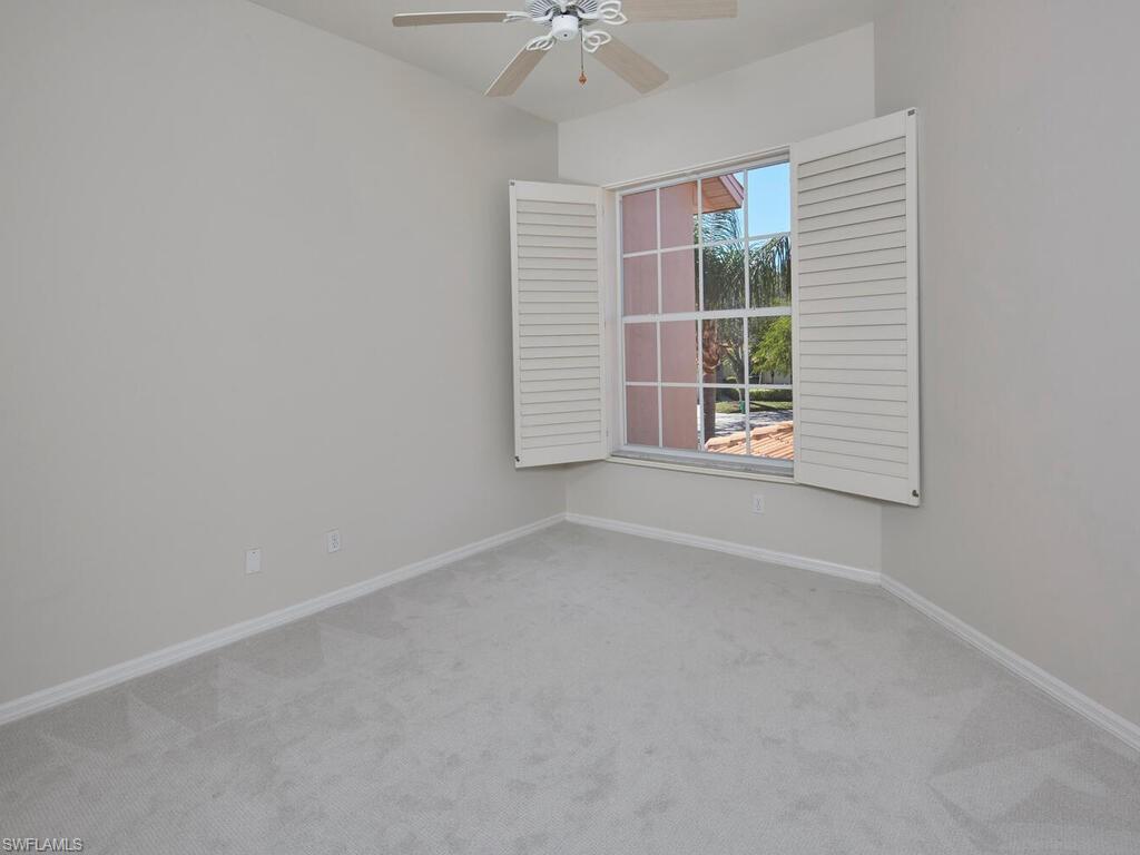 1033 Egrets Walk Circle, Unit 203 Naples, FL 34108 - Photo 23 of 35 an empty room with a window