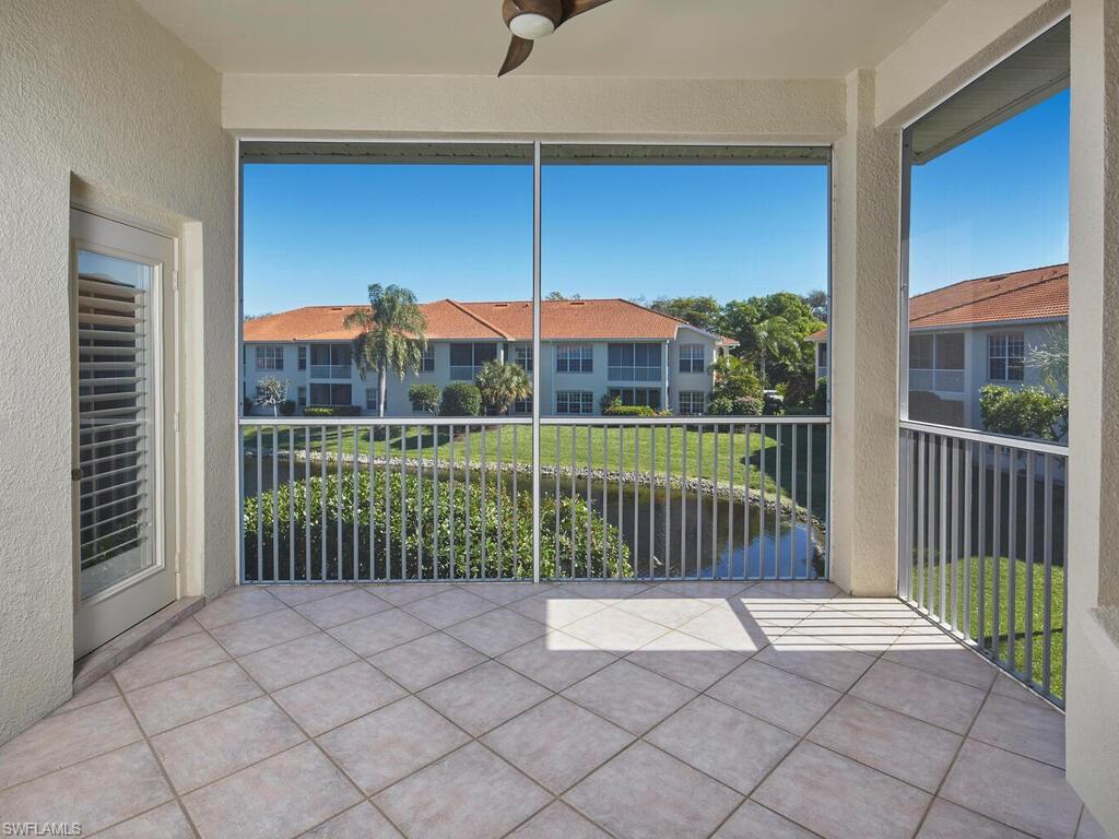 1033 Egrets Walk Circle, Unit 203 Naples, FL 34108 - Photo 24 of 35 a view of a house with a backyard and porch