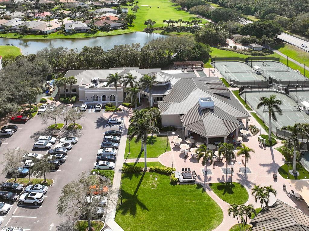 1033 Egrets Walk Circle, Unit 203 Naples, FL 34108 - Photo 31 of 35 an aerial view of a house with a swimming pool yard and lake view in back