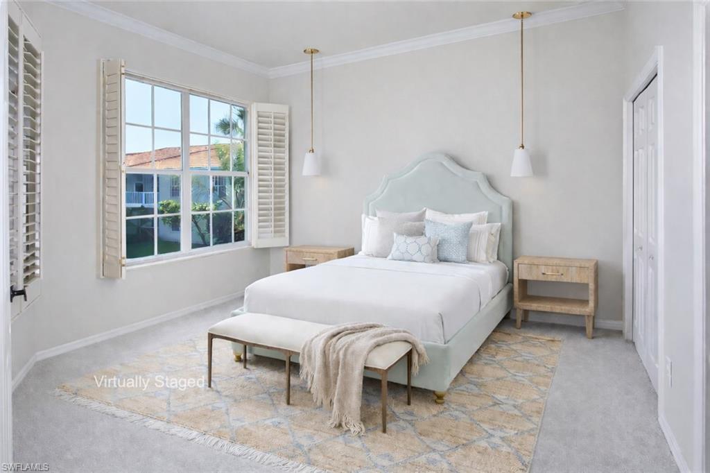 1033 Egrets Walk Circle, Unit 203 Naples, FL 34108 - Photo 8 of 35 a bedroom with a bed and a large window