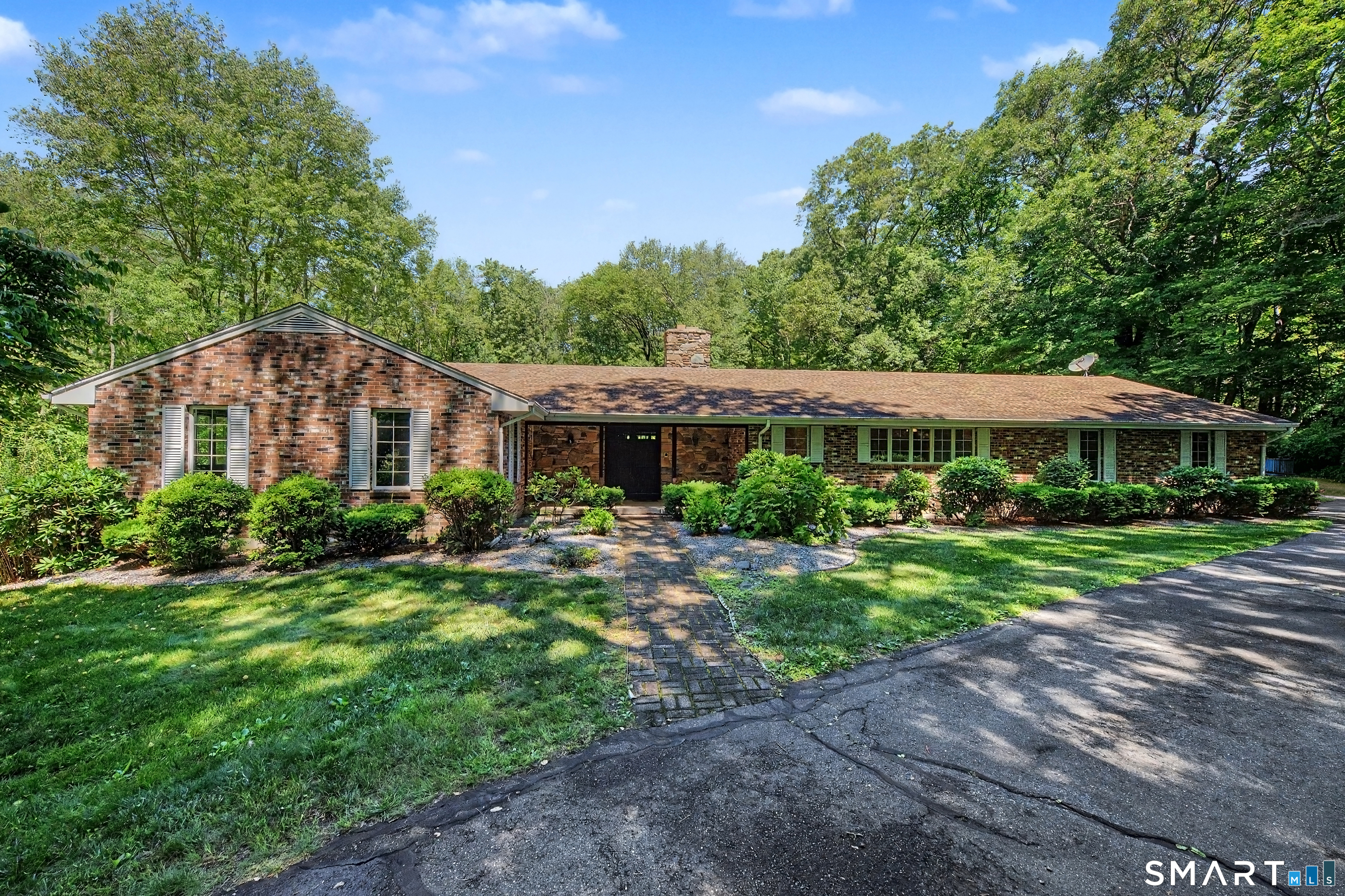 Majestic masonry ranch with circular driveway on over 6 acres of land.