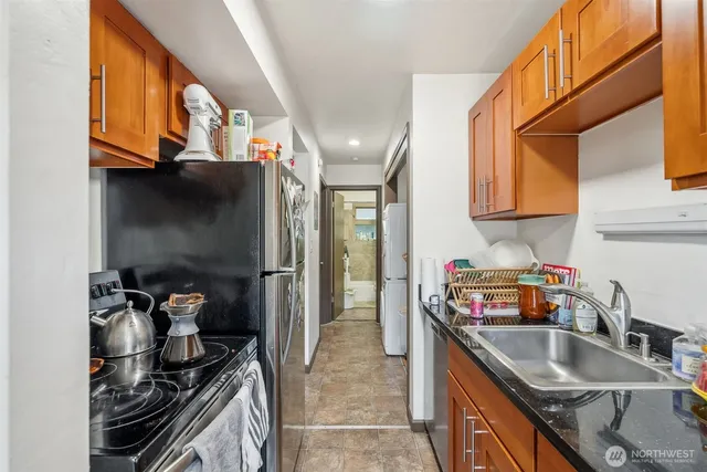 a kitchen with stainless steel appliances granite countertop a sink stove and refrigerator