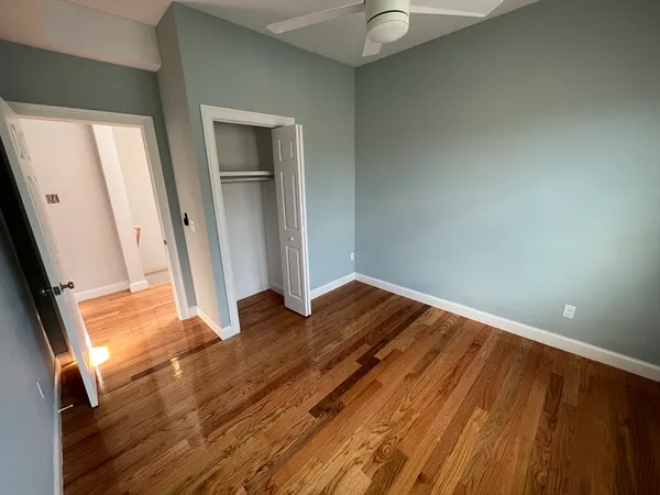 a view of a room with wooden floor and staircase