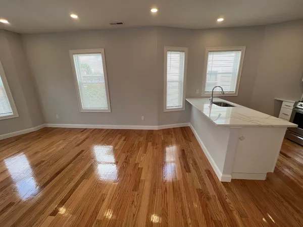 a room with wooden floors and windows