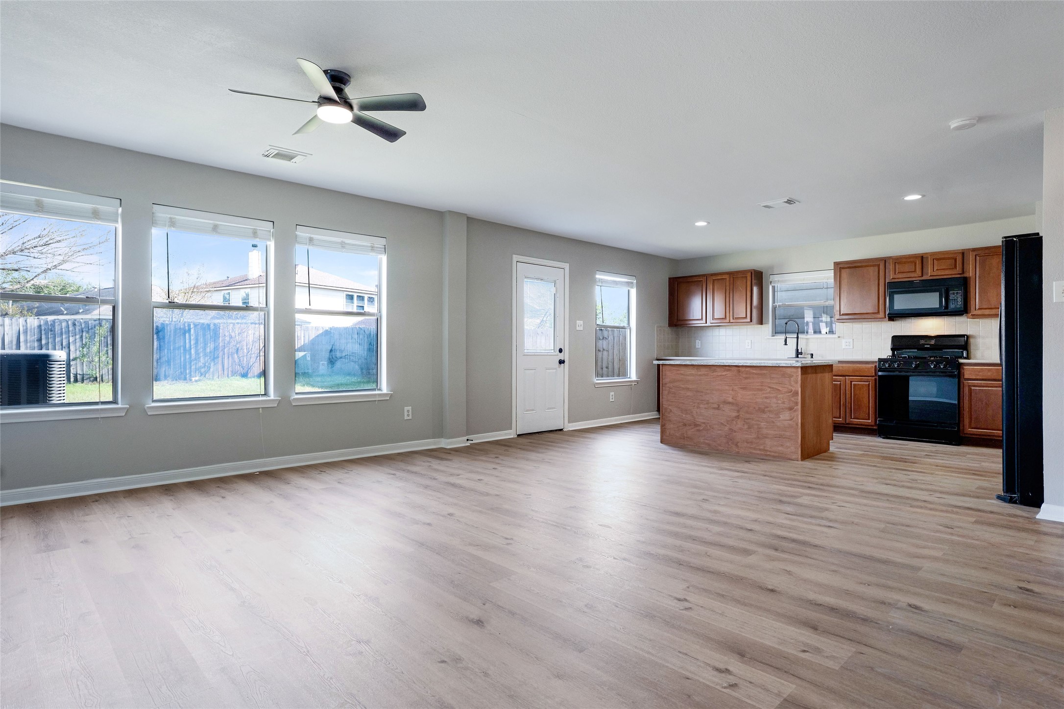 3630 Avalon Castle Drive Spring, TX 77386 - Photo 15 of 39 Open-concept main living area with updated flooring, natural light, and effortless flow into the kitchen