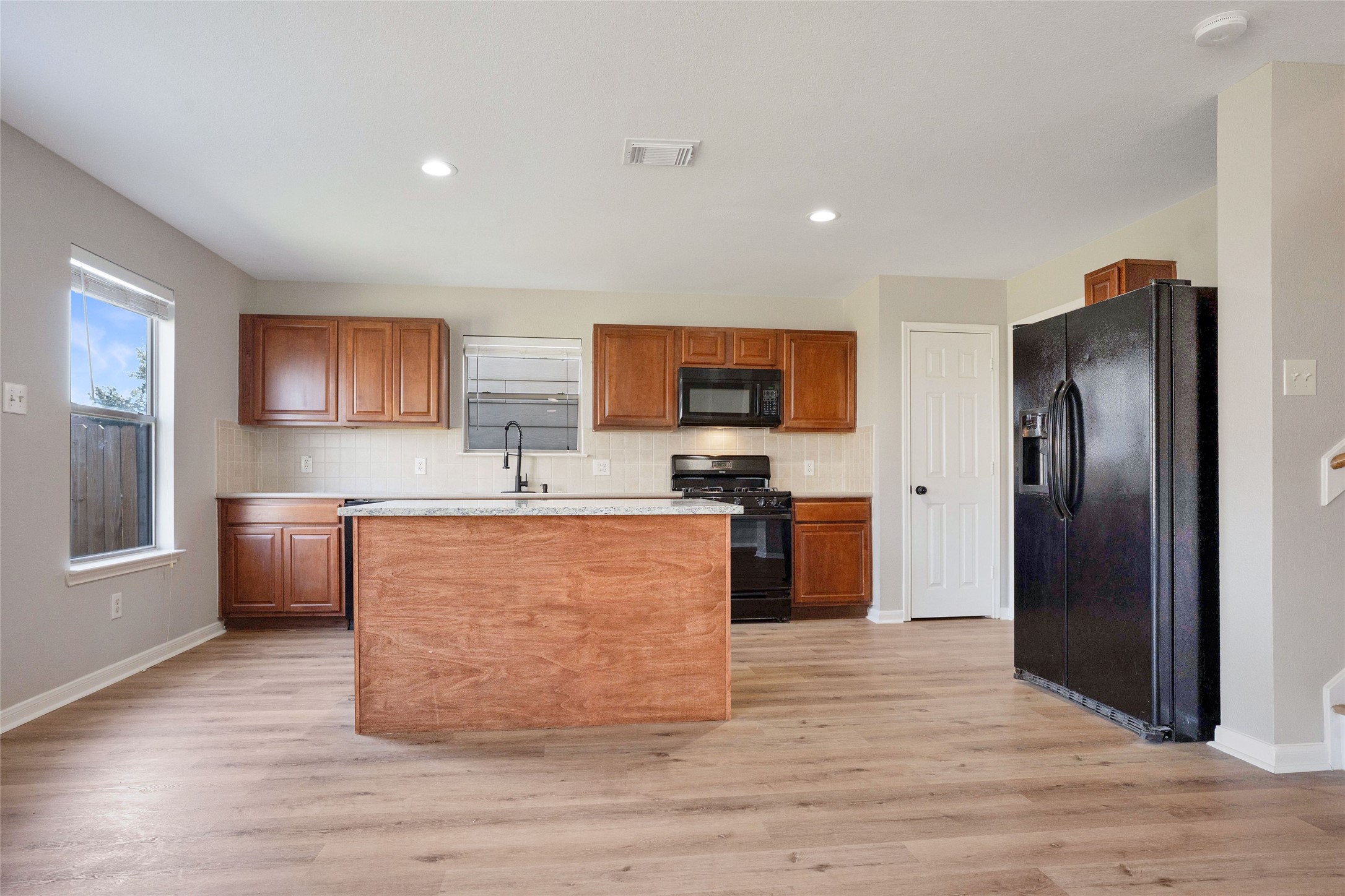 3630 Avalon Castle Drive Spring, TX 77386 - Photo 16 of 39 a large kitchen with stainless steel appliances granite countertop a stove a sink dishwasher a refrigerator and a stove with wooden floor