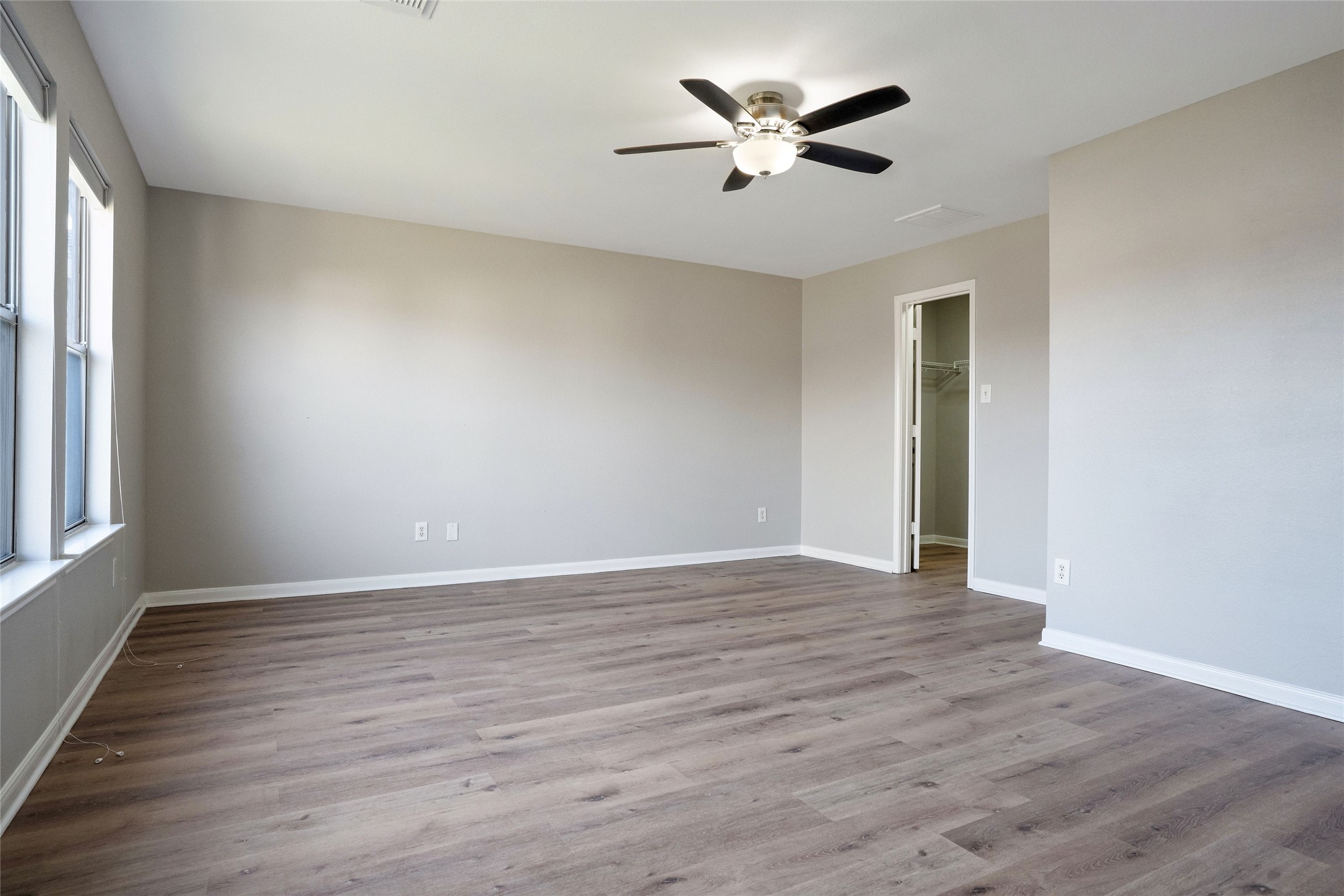 3630 Avalon Castle Drive Spring, TX 77386 - Photo 21 of 39 an empty room with wooden floor and ceiling fan
